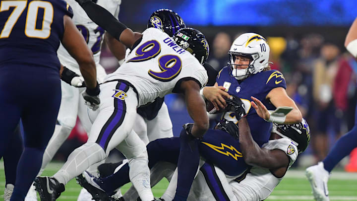 Nov 25, 2024; Inglewood, California, USA; Los Angeles Chargers quarterback Justin Herbert (10) is sacked by Baltimore Ravens cornerback Brandon Stephens (21) and linebacker Odafe Oweh (99) during the second half at SoFi Stadium. Mandatory Credit: Gary A. Vasquez-Imagn Images Nov 25, 2024; Inglewood, California, USA; Los Angeles Chargers quarterback Justin Herbert (10) is sacked by Baltimore Ravens cornerback Brandon Stephens (21) and linebacker Odafe Oweh (99) during the second half at SoFi Stadium. Mandatory Credit: Gary A. Vasquez-Imagn Images