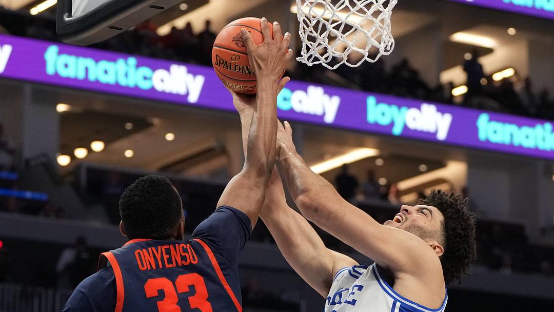 Mar 14, 2026; Charlotte, NC, USA; Duke Blue Devils forward Cameron Boozer (12) with the ball as Virginia Cavaliers center Ugonna Onyenso (33) defends in the second half during the men's ACC Conference Tournament Championship at Spectrum Center. Mandatory Credit: Bob Donnan-Imagn Images