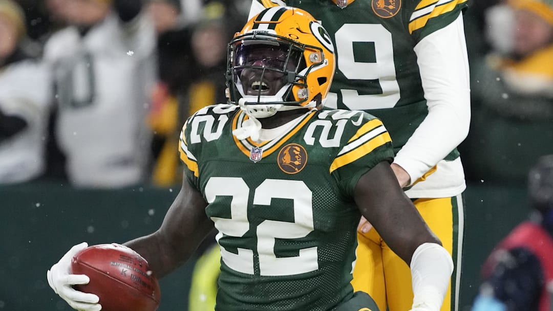 Nov 28, 2024; Green Bay, Wisconsin, USA;  Green Bay Packers cornerback Robert Rochell (22) celebrates with punter Daniel Whelan (19) after recovering a fumbel during the first quarter against the Miami Dolphins at Lambeau Field. Mandatory Credit: Jeff Hanisch-Imagn Images