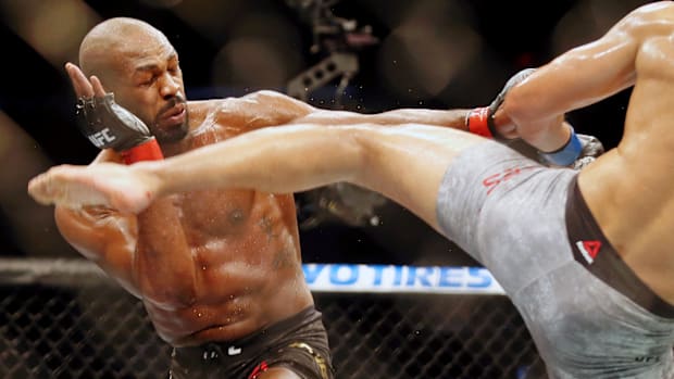 Jon Jones (red gloves) fights Dominick Reyes (blue gloves) during UFC 247 at Toyota Center.