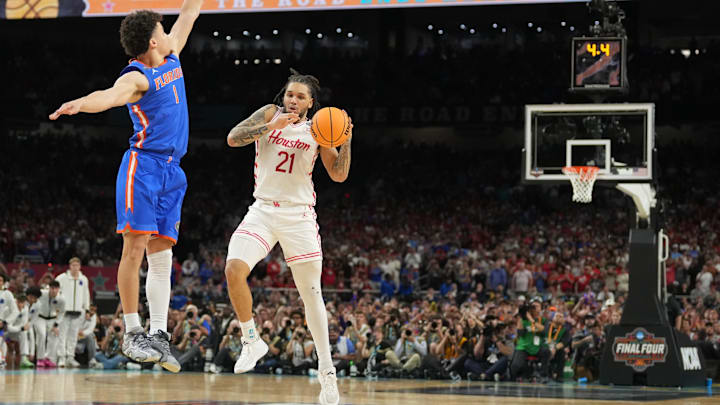 Apr 7, 2025; San Antonio, TX, USA; Houston Cougars guard Emanuel Sharp (21) loses the ball as he attempts to shoot against Florida Gators guard Walter Clayton Jr. (1)  in the second half in the national championship game of the Final Four of the 2025 NCAA Tournament at the Alamodome. Mandatory Credit: Robert Deutsch-Imagn Images