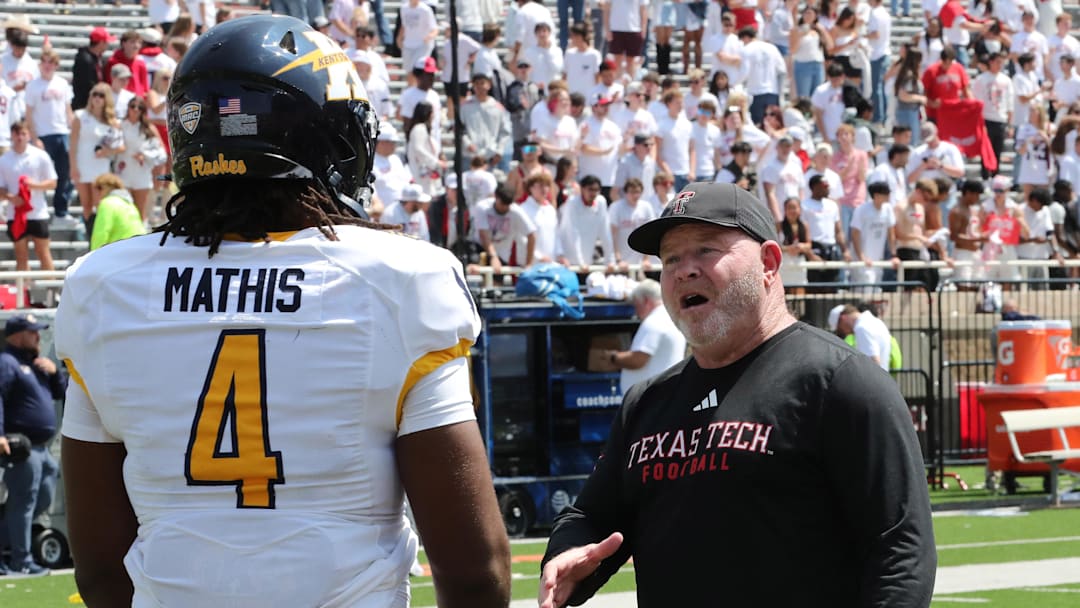 Texas Tech Red Raiders associate head coach Kenny Perry visits with Kent State Golden Flashes defensive end Jamond Mathis (4) after the game at Jones AT&T Stadium. 