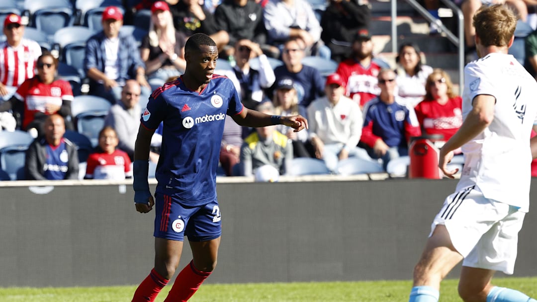Oct 9, 2022; Chicago, Illinois, USA; Chicago Fire forward Jhon Duran (26) makes a pass against New England Revolution defender Henry Kessler (4) during the second half at Bridgeview Stadium. Mandatory Credit: Mike Dinovo-Imagn Images