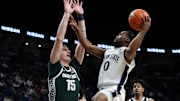Former Penn State basketball player Kanye Clary drives the ball to the basket as Michigan State Spartans center Carson Cooper defends during a 2024 Big Ten game at Bryce Jordan Center.