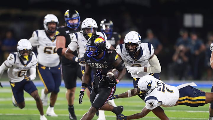 Kansas Jayhawks running back Leshon Williams (4) runs the ball during the second half of the game against West Virginia Mountaineers at David Booth Kansas Memorial Stadium on Sept. 20, 2025.