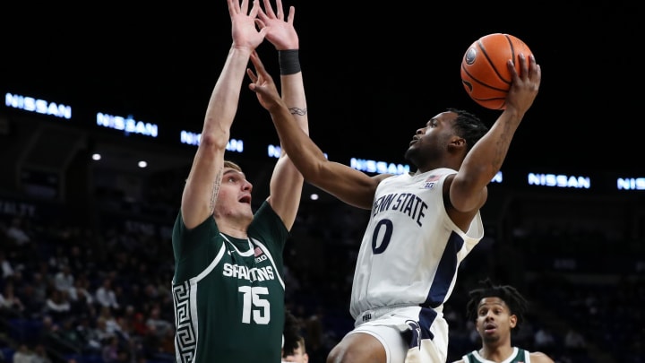 Feb 14, 2024; University Park, Pennsylvania, USA; Penn State Nittany Lions guard Kanye Clary (0) drives the ball to the basket as Michigan State Spartans center Carson Cooper (15) defends during the first half at Bryce Jordan Center. Michigan State defeated Penn State 80-72. Mandatory Credit: Matthew O'Haren-USA TODAY Sports