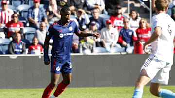 Oct 9, 2022; Chicago, Illinois, USA; Chicago Fire forward Jhon Duran (26) makes a pass against New England Revolution defender Henry Kessler (4) during the second half at Bridgeview Stadium. Mandatory Credit: Mike Dinovo-Imagn Images