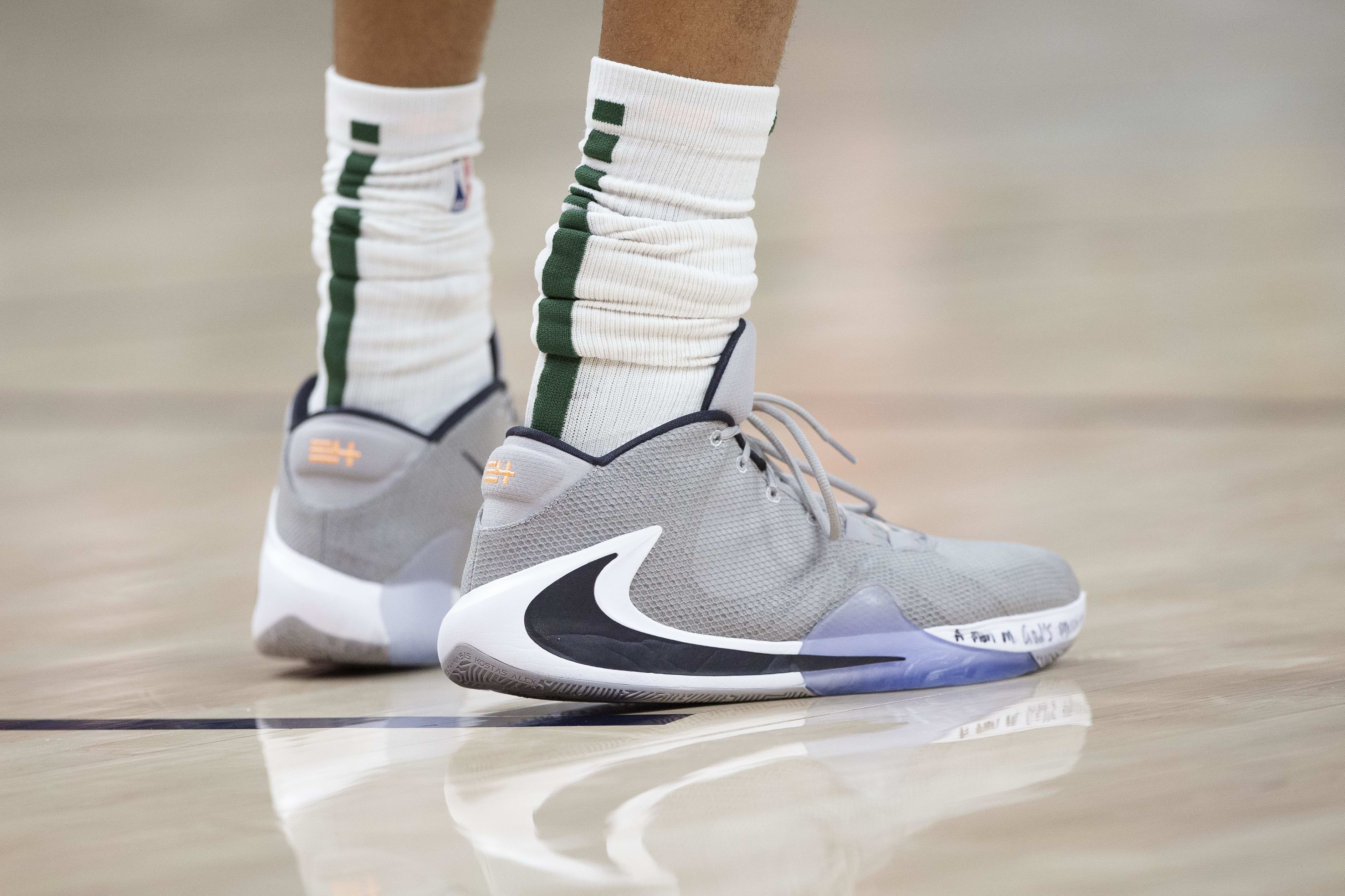 Milwaukee Bucks forward Giannis Antetokounmpo's grey and white Nike sneakers.