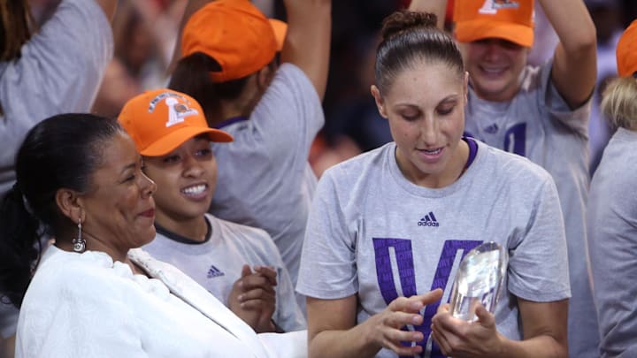 Sep 12, 2014; Chicago, IL, USA; Phoenix Mercury guard Diana Taurasi (right) is presented with the MVP trophy after game three of the 2014 WNBA Finals against the Chicago Sky at UIC Pavilion. Mandatory Credit: Jerry Lai-Imagn Images