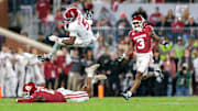 Nov 23, 2024; Norman, Oklahoma, USA; Alabama Crimson Tide wide receiver Germie Bernard (5) is up ended during the first quarter against the Oklahoma Sooners at Gaylord Family-Oklahoma Memorial Stadium. Mandatory Credit: William Purnell-Imagn Images