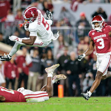 Nov 23, 2024; Norman, Oklahoma, USA; Alabama Crimson Tide wide receiver Germie Bernard (5) is up ended during the first quarter against the Oklahoma Sooners at Gaylord Family-Oklahoma Memorial Stadium. Mandatory Credit: William Purnell-Imagn Images