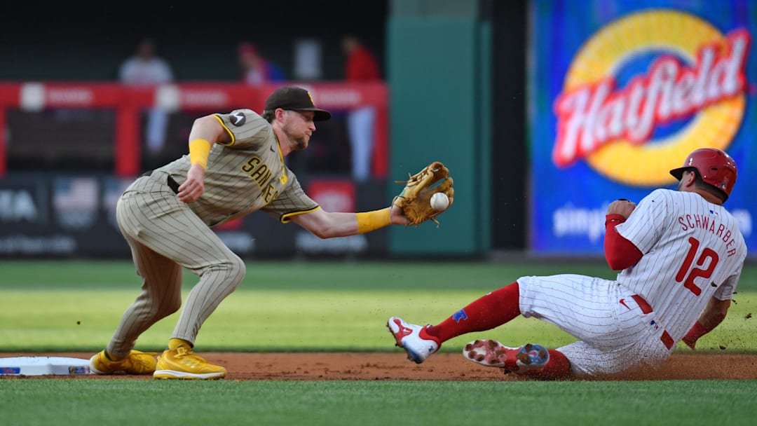 Jun 17, 2024; Philadelphia, Pennsylvania, USA; San Diego Padres shortstop Ha-Seong Kim (7) gets set to tag out Philadelphia Phillies designated hitter Kyle Schwarber (12) who was caught stealing during the first inning at Citizens Bank Park. Mandatory Credit: Eric Hartline-Imagn Images