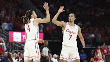 Dec 6, 2025; Houston, TX, USA; Houston Cougars guard Milos Uzan (7) celebrates with guard Kingston Flemings (4) after a play during the second half against the Florida State Seminoles at Toyota Center. Mandatory Credit: Troy Taormina-Imagn Images