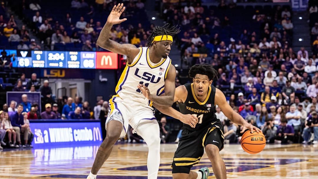 Jan 4, 2025; Baton Rouge, Louisiana, USA;  Vanderbilt Commodores guard AJ Hoggard (11) brings the ball up court against LSU Tigers forward Corey Chest (left) during the second half at Pete Maravich Assembly Center. 