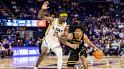 Jan 4, 2025; Baton Rouge, Louisiana, USA;  Vanderbilt Commodores guard AJ Hoggard (11) brings the ball up court against LSU Tigers forward Corey Chest (left) during the second half at Pete Maravich Assembly Center. 