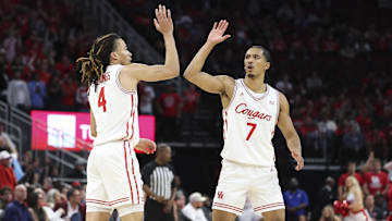 Houston Cougars guard Milos Uzan celebrates with guard Kingston Flemings after a play during the second half against the Florida State Seminoles at Toyota Center.
