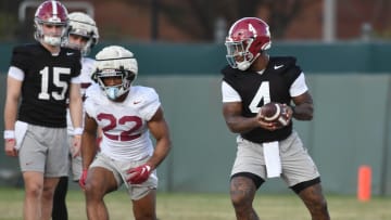 Mar 6, 2024; Tuscaloosa, Alabama, USA; Jalen Milroe turns to hand the ball off to Justice Haynes during practice for the Alabama Crimson Tide football team Wednesday.