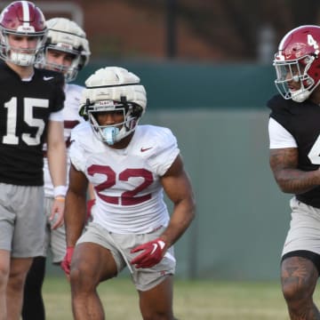 Mar 6, 2024; Tuscaloosa, Alabama, USA; Jalen Milroe turns to hand the ball off to Justice Haynes during practice for the Alabama Crimson Tide football team Wednesday.