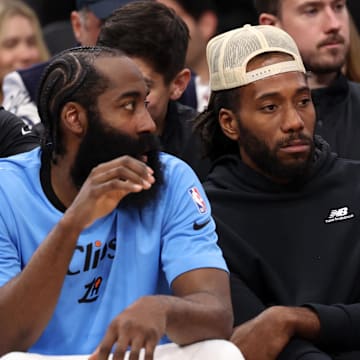 Nov 17, 2024; Inglewood, California, USA;  Los Angeles Clippers guard James Harden (1, left) and Kawhi Leonard (right) watch the game against the Utah Jazz from the bench during the fourth quarter at Intuit Dome. Mandatory Credit: Kiyoshi Mio-Imagn Images