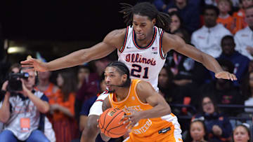 Dec 14, 2024; Champaign, Illinois, USA;  Illinois Fighting Illini forward Morez Johnson Jr. (21) guards Tennessee Volunteers guard Zakai Zeigler (5) during the first half at State Farm Center. Mandatory Credit: Ron Johnson-Imagn Images