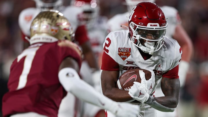 Dec 29, 2022; Orlando, Florida, USA; Oklahoma Sooners running back Jovantae Barnes (2) runs with the ball against the Florida State Seminoles in the first quarter during  the 2022 Cheez-It Bowl at Camping World Stadium. Mandatory Credit: Nathan Ray Seebeck-USA TODAY Sports