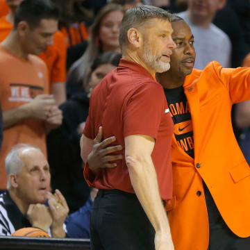 Oklahoma Sooners head coach Porter Moser and Oklahoma State Cowboys head coach Mike Boynton talk before a men's Bedlam college basketball game between the Oklahoma State University Cowboys (OSU) and the University of Oklahoma Sooners (OU) at Gallagher-Iba Arena in Stillwater, Okla., Wednesday, Jan. 18, 2023.