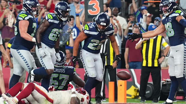 Seattle Seahawks running back Zach Charbonnet (26) celebrates with tight end AJ Barner (88)