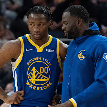 October 30, 2021; San Francisco, California, USA; Golden State Warriors forward Jonathan Kuminga (00) listens to forward Draymond Green (23) during the fourth quarter against the Oklahoma City Thunder at Chase Center. Mandatory Credit: Kyle Terada-Imagn Images