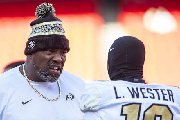 Nov 23, 2024; Kansas City, Missouri, USA;  Colorado coach Warren Sapp motivates Colorado wide receiver LaJohntay Wester (10) 