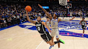 Dec 21, 2024; Memphis, Tennessee, USA; Mississippi State Bulldogs guard Claudell Harris Jr. (0) shoots over Memphis Tigers guard Colby Rogers (3) during the first half  at FedExForum. Mandatory Credit: Wesley Hale-Imagn Images