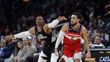 Jan 31, 2024; Washington, District of Columbia, USA; LA Clippers guard Russell Westbrook (0) and Washington Wizards guard Tyus Jones (5) chase a loose ball in the first half at Capital One Arena. Mandatory Credit: Geoff Burke-USA TODAY Sports
