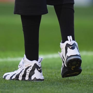 Colorado Buffaloes head coach Deion Sanders wears the Nike Air DT Max '96 sneakers in the "Colorado Away" colorway.