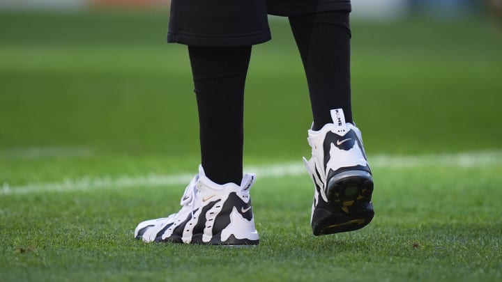 Colorado Buffaloes head coach Deion Sanders wears the Nike Air DT Max '96 sneakers in the "Colorado Away" colorway.