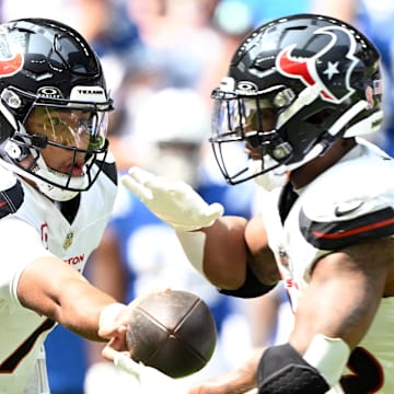 Sep 8, 2024; Indianapolis, Indiana, USA; Houston Texans quarterback C.J. Stroud (7) hands the ball off to Houston Texans running back Joe Mixon (28) during the second quarter at Lucas Oil Stadium. Mandatory Credit: Marc Lebryk-Imagn Images