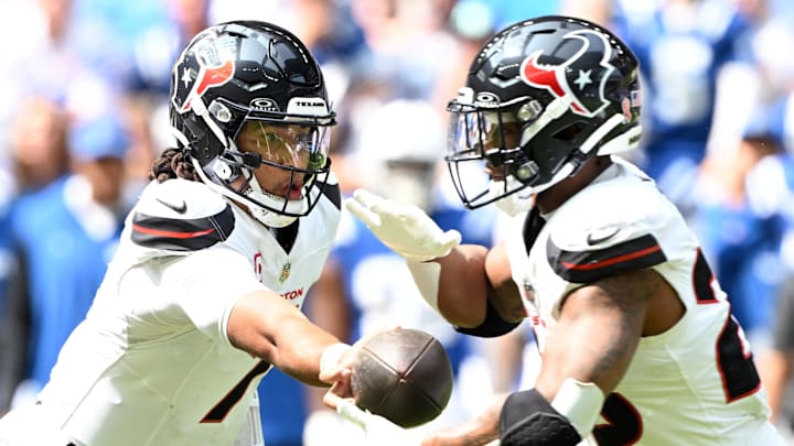 Sep 8, 2024; Indianapolis, Indiana, USA; Houston Texans quarterback C.J. Stroud (7) hands the ball off to Houston Texans running back Joe Mixon (28) during the second quarter at Lucas Oil Stadium. Mandatory Credit: Marc Lebryk-Imagn Images