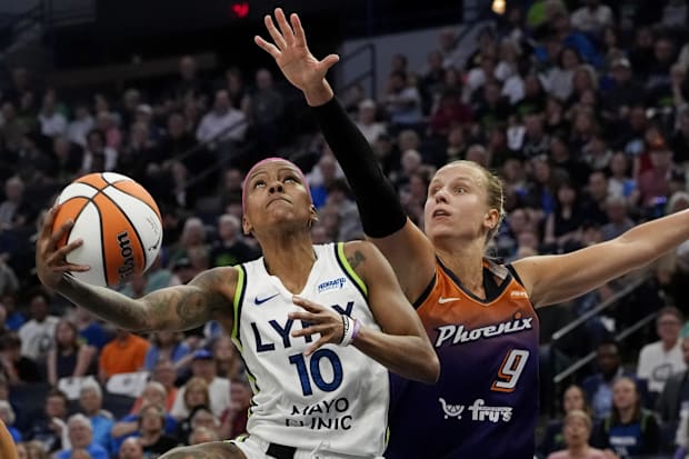 Minnesota Lynx guard Courtney Williams (10) goes to the basket against Phoenix Mercury guard Kitija Laksa (9)