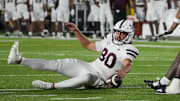 Mississippi State Bulldogs place kicker Kyle Ferrie (80) chases after a bad snap as several Missouri Tigers defenders attempt the fumble recovery during the first half of the game at Faurot Field at Memorial Stadium.
