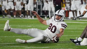 Mississippi State Bulldogs place kicker Kyle Ferrie (80) chases after a bad snap as several Missouri Tigers defenders attempt the fumble recovery during the first half of the game at Faurot Field at Memorial Stadium.