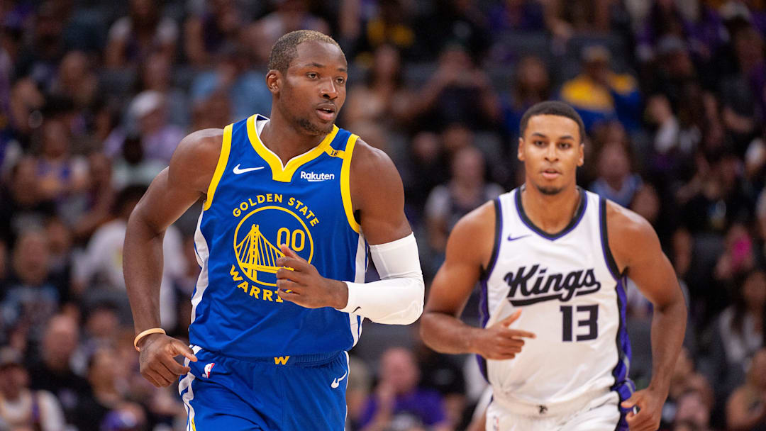 Oct 9, 2024; Sacramento, California, USA; Golden State Warriors forward Jonathan Kuminga (00) and Sacramento Kings forward Keegan Murray (13) jog up the court during the first quarter at Golden 1 Center. Mandatory Credit: Ed Szczepanski-Imagn Images