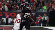 Dec 14, 2025; Houston, Texas, USA; Houston Texans running back Woody Marks (27) celebrates a touchdown during the first quarter against the Arizona Cardinals at NRG Stadium. Mandatory Credit: Thomas Shea-Imagn Images