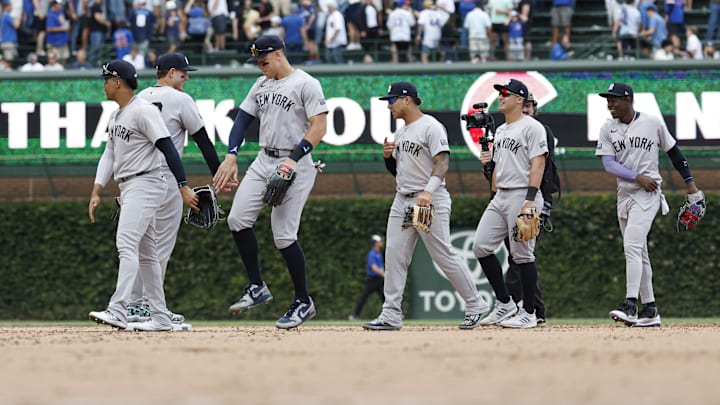 Sep 6, 2024; Chicago, Illinois, USA; New York Yankees players celebrate after defeating the Chicago Cubs in a baseball game at Wrigley Field. Mandatory Credit: Kamil Krzaczynski-Imagn Images