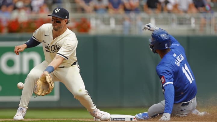 Aug 14, 2024; Minneapolis, Minnesota, USA; Kansas City Royals pinch runner Maikel Garcia (11) steals second base against Minnesota Twins second baseman Kyle Farmer (12) in the seventh inning at Target Field. Mandatory Credit: Bruce Kluckhohn-USA TODAY Sports