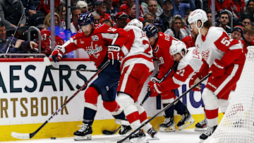 Mar 18, 2025; Washington, District of Columbia, USA; Washington Capitals right wing Taylor Raddysh (16) goes for the puck against Detroit Red Wings defenseman Albert Johansson (20) during the first period at Capital One Arena. Mandatory Credit: Peter Casey-Imagn Images