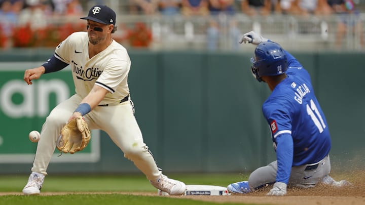 Aug 14, 2024; Minneapolis, Minnesota, USA; Kansas City Royals pinch runner Maikel Garcia (11) steals second base against Minnesota Twins second baseman Kyle Farmer (12) in the seventh inning at Target Field. Mandatory Credit: Bruce Kluckhohn-Imagn Images