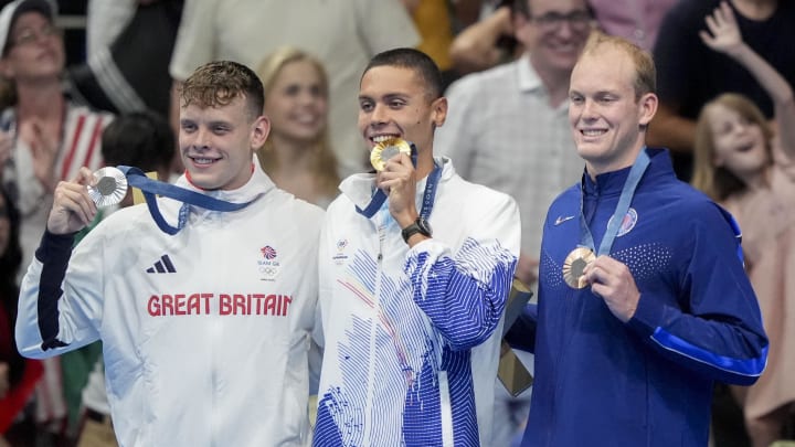 Jul 29, 2024; Nanterre, France; Matthew Richards (Great Britain), David Popvici (Romania) and Luke Hobson (USA) in the men’s 200-meter freestyle medal ceremony during the Paris 2024 Olympic Summer Games at Paris La Défense Arena. Mandatory Credit: Grace Hollars-USA TODAY Sports