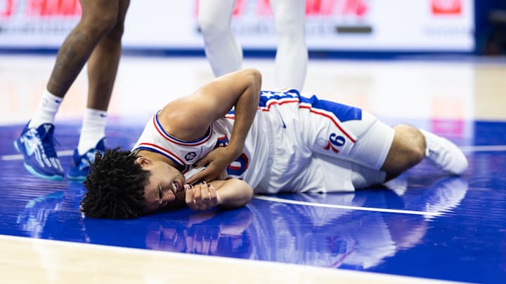 Oct 16, 2024; Philadelphia, Pennsylvania, USA; Former Duke basketball guard Jared McCain (20) reacts on the floor after being injured on a play against the Brooklyn Nets during the fourth quarter at Wells Fargo Center