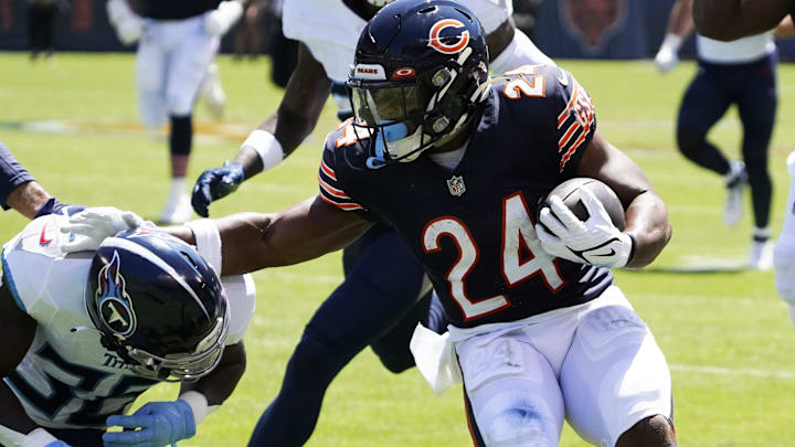 Khalil Herbert breaks free and stiff-arms to find extra yardage against the titans in preseason play.