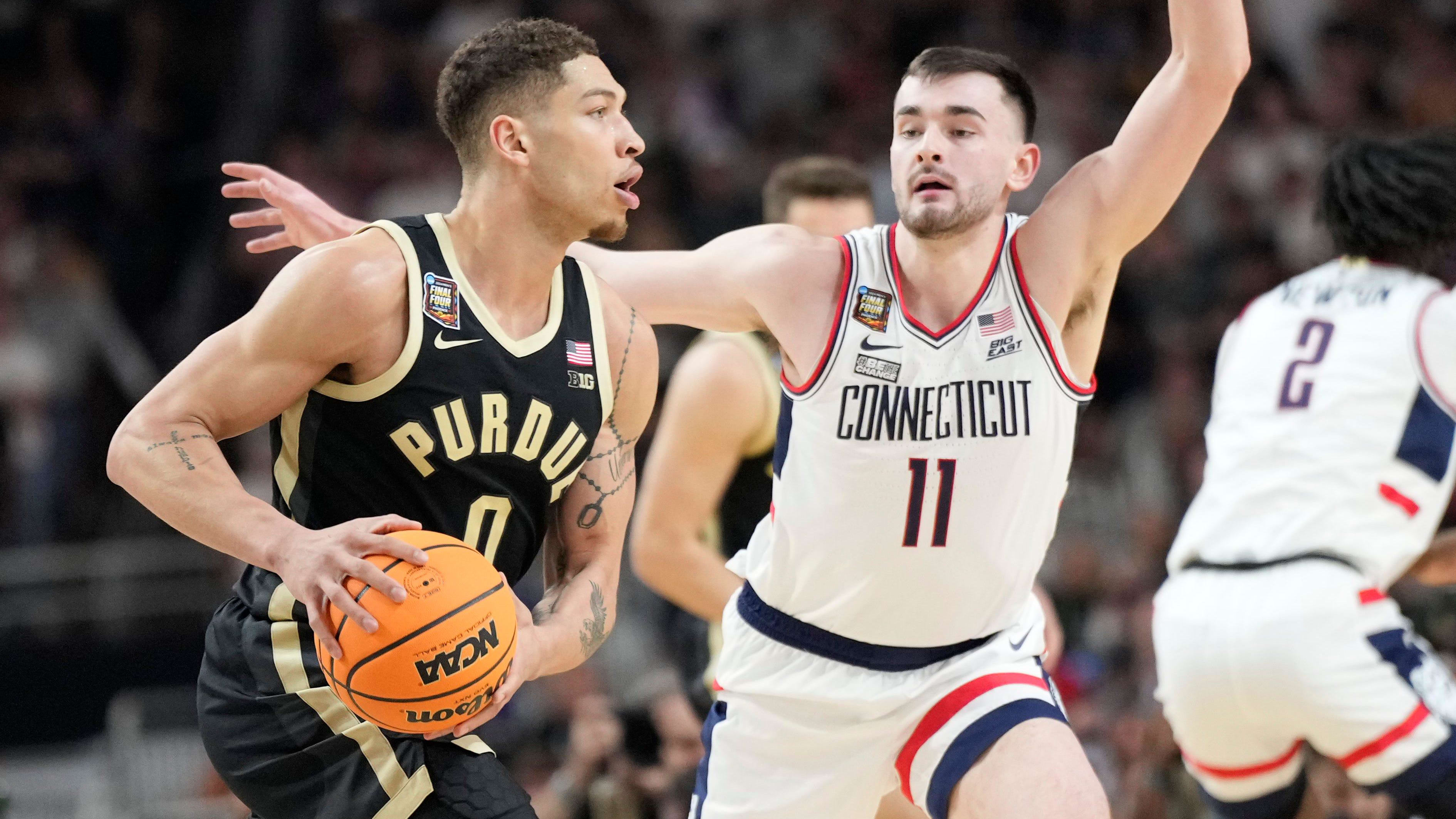 Purdue Boilermakers forward Mason Gillis is guarded by Connecticut Huskies forward Alex Karaban