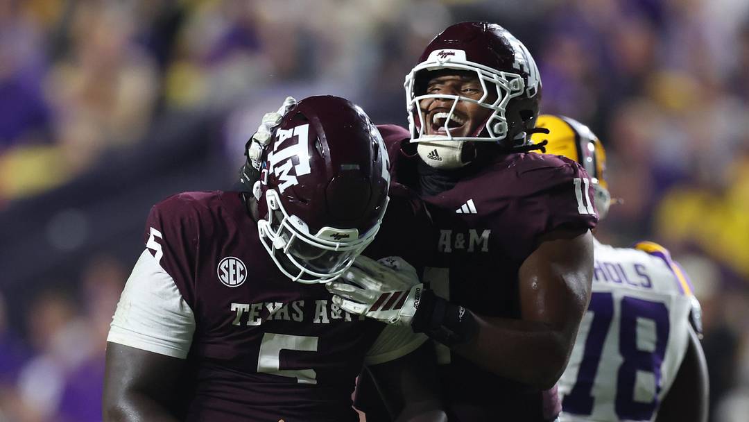 Oct 25, 2025; Baton Rouge, Louisiana, USA; Texas A&M Aggies defensive tackle DJ Hicks (5) celebrates with defensive tackle Tyler Onyedim (11) after a play during the second half against the Louisiana State Tigers at Tiger Stadium. Mandatory Credit: Stephen Lew-Imagn Images