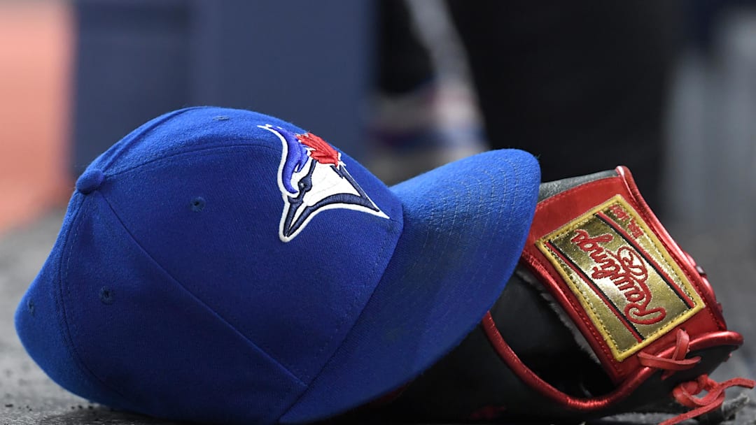 A baseball cap and glove sit on the Toronto Blue Jays dugout steps as they host the Seattle Mariners in their home opener at Rogers Centre in Toronto on April 8, 2024.